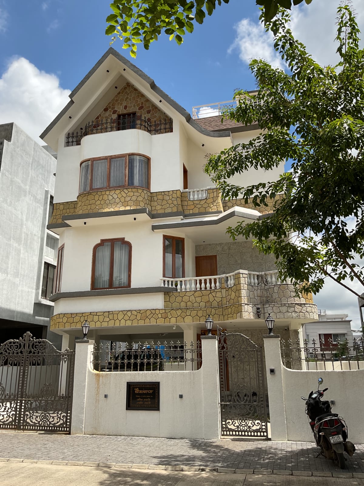 Multi-story luxury residential villa exterior elevation clad in premium natural stone cladding