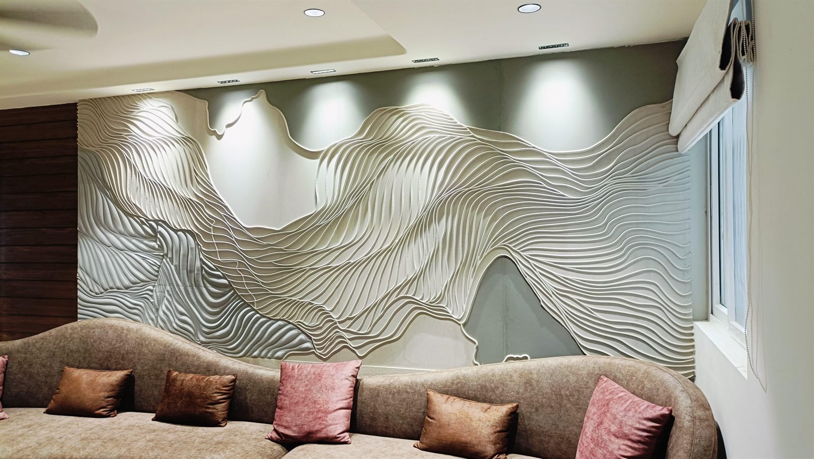 Contemporary living space with 3D parametric sculpted stone wave wall mural behind sofa